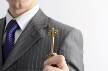 Businessman with a key clipart