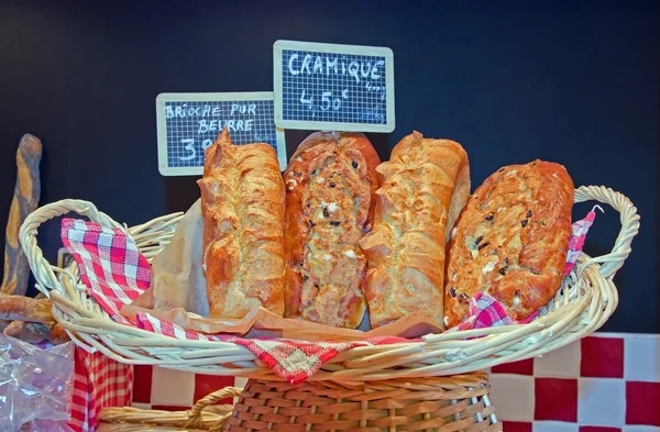 Broodjes en rozijnenbrood in een mand — Stockfoto