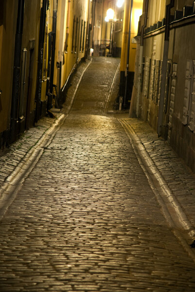 Empty narrow street with cobblestones in the old town of Stockholm, Sweden