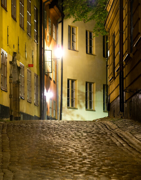 Narrow street at night in the old town (Gamla Stan) of Stockholm, sweden