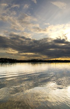 Snset with clouds reflected in water clipart