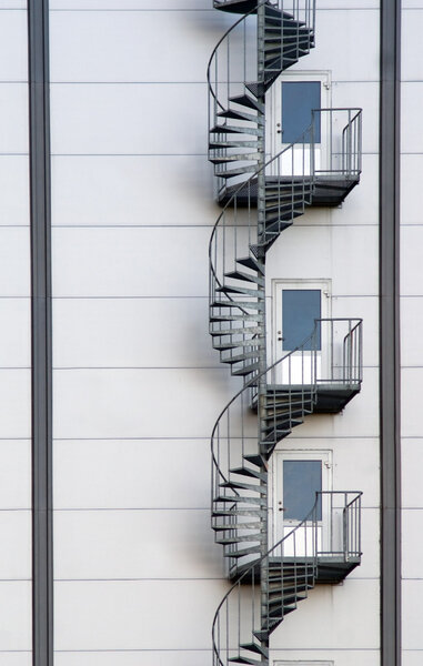 Spiral fire escape on a white wall