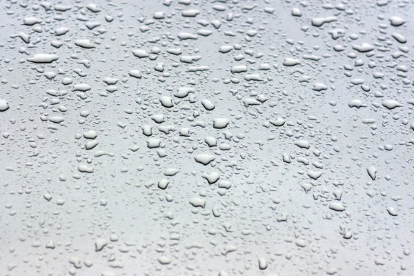 Капли дождя на металл — стоковое фото