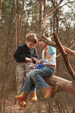 Children play outside in a forest clipart