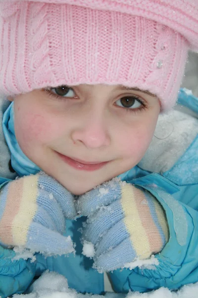 Kleines Mädchen mit rosa Wintermütze im Schnee — Stockfoto