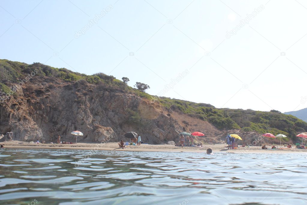 Coast of Sardinia, sea, sand and rocks with blue sky