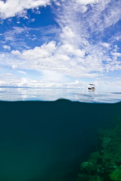 stock image Small boat on the reef