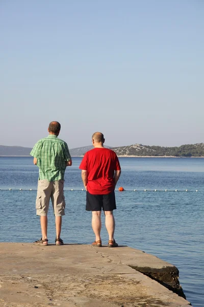 stock image Men looking at the blue Adriatic sea in Croatia