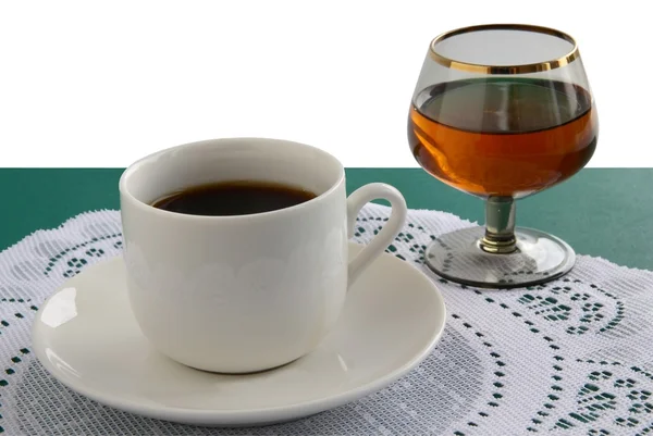 Kopje koffie en een glas cognac — Stockfoto