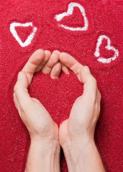 Hands and red hearts — Stock Photo, Image
