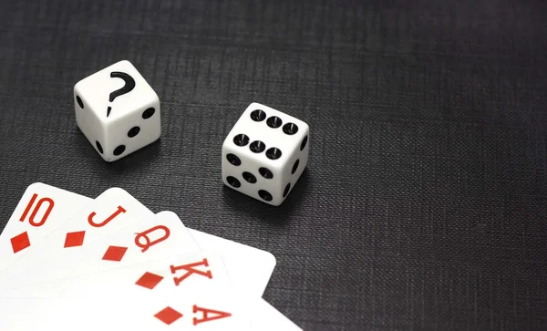 Dices and playing cards on a black background — Stock Photo, Image