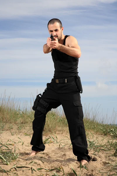 Male bodyguard with a gun — Stock Photo, Image