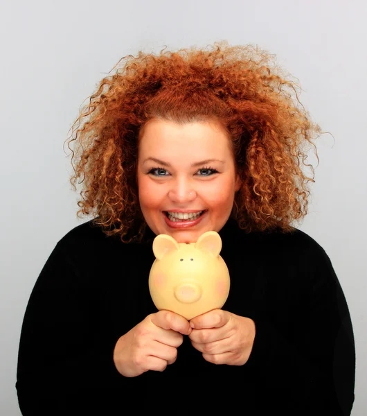 stock image Girl with a piggy bank