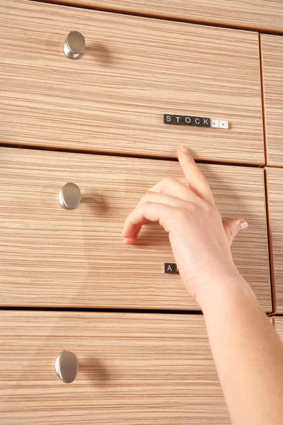 Stock drawer and a hand showing it — Stock Photo, Image