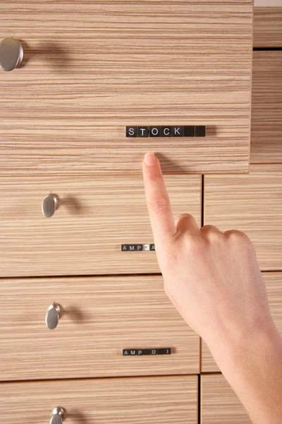 Stock drawer and a hand showing it — Stock Photo, Image