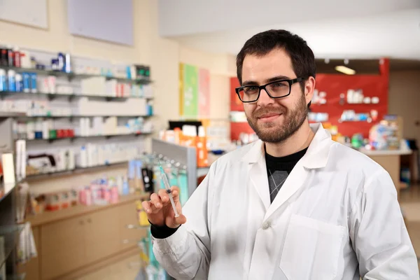 Pharmacist holding an injection — Stock Photo, Image
