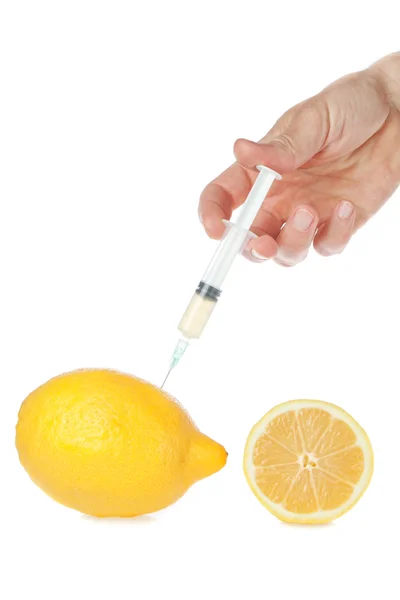 La siringa in mano con limone. su uno sfondo bianco. — Foto Stock