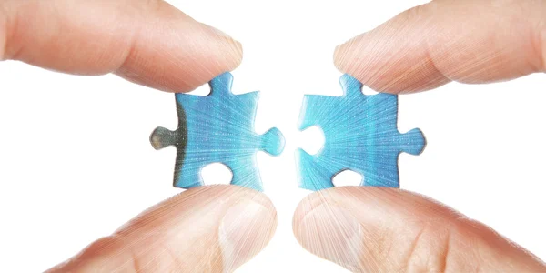 Connecting two puzzles in the rays. On a white background. — Stock Photo, Image