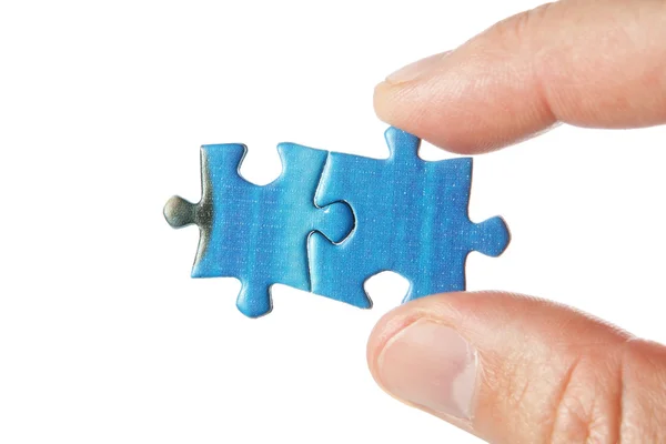 United two puzzle in the fingers. On a white background. — Stock Photo, Image