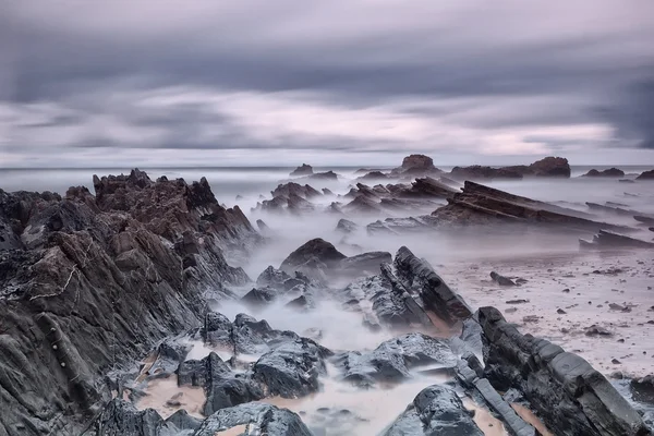 Marine rocks in diffuse waves. Portugal. — Stock Photo, Image