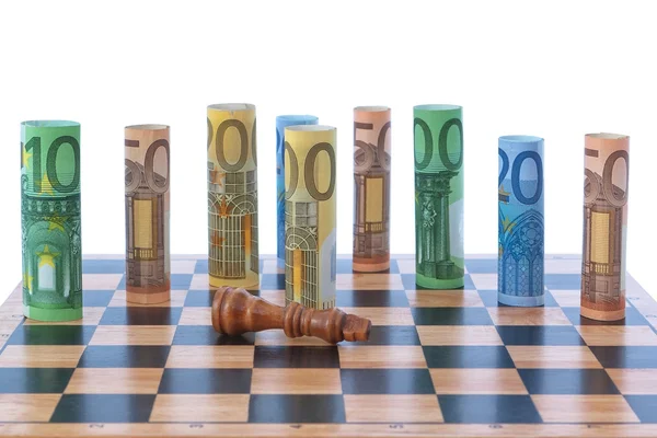 The figure of the money on a chessboard. — Stock Photo, Image