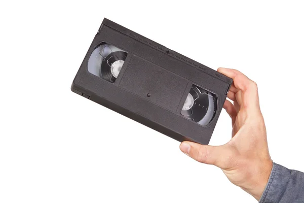 Video kaset, video kaset elinde. Beyaz bir arka plan üzerinde. — Stok fotoğraf