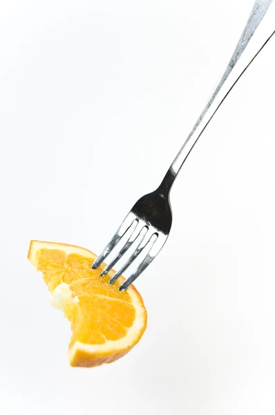 stock image Slice of fresh orange on the fork