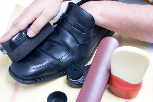 Cleaning shoes Stock Image