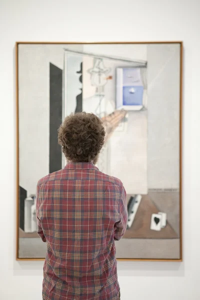 stock image Man is watching a art piece