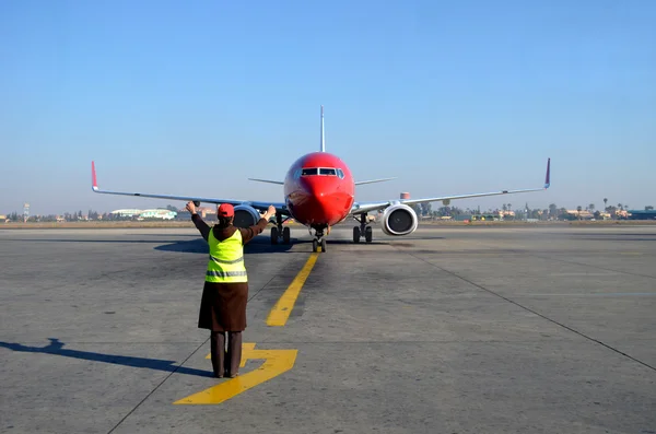 stock image Woman signalling plane at airport