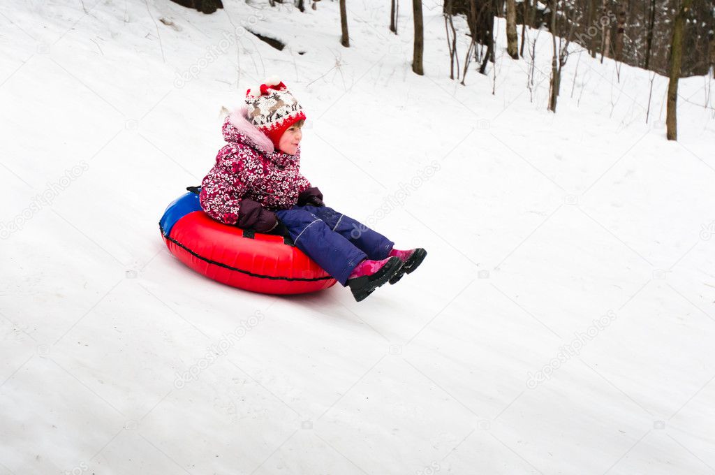 Child on inflatable sleds