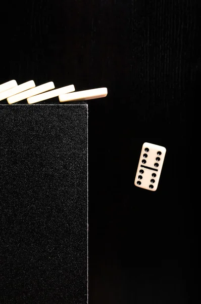 Domino dropping from the edge — Stock Photo, Image