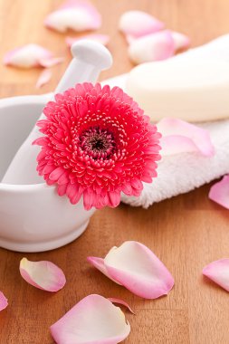 Soap with rose leafs on towel and mortar clipart