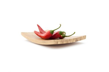 Red chilli peppers on wooden board clipart