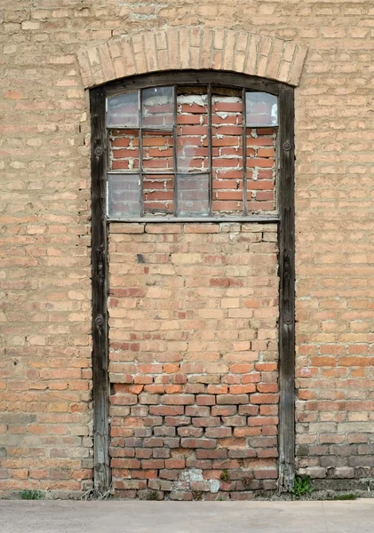Sealed door with brick wall — Stock Photo, Image