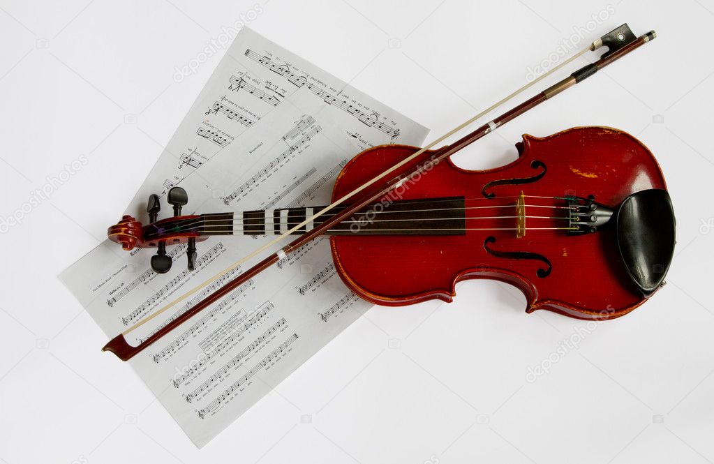 Old Violin closeup with notes and bow.