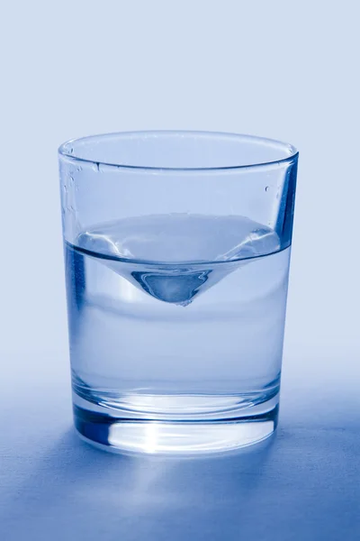 Glass of wather on blue background — Stock Photo, Image