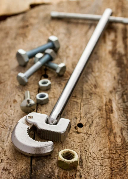 Chrome wrench and set of nuts bolts — Stock Photo, Image