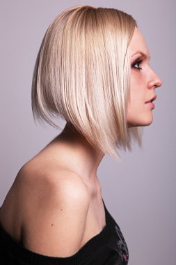 Pretty blond girl in profile clipart