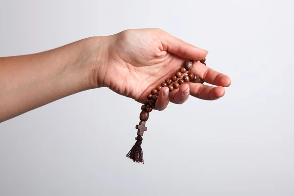 A hand and rosary — Stock Photo, Image