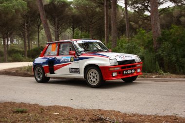 MARINHA GRANDE, PORTUGAL - APRIL 14: Anibal Rolo drives a Renault 5 Turbo during Rally Vidreiro 2012, integrated on Open Championship in Marinha Grande, Portugal on April 14, 2012. clipart