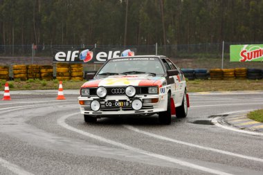 LEIRIA, PORTUGAL - APRIL 20: Cipriano Antunes drives a Audi Quattro during Day One of Rally Verde Pino 2012, in Leiria, Portugal on April 20, 2012. clipart