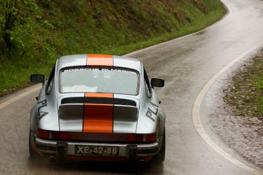 LEIRIA, PORTUGAL - APRIL 21: Pedro L Antunes drives a Porsche 911 during Day Two of Rally Verde Pino 2012, in Leiria, Portugal on April 21, 2012. clipart