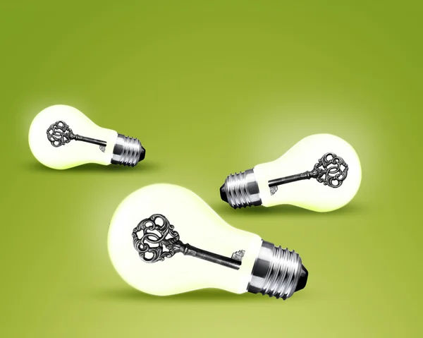 Old key in light bulb — Stock Photo, Image