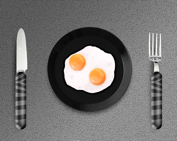 Dos huevos fritos en un plato — Foto de Stock