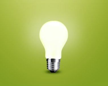 Glowing Light bulb idea on green background clipart