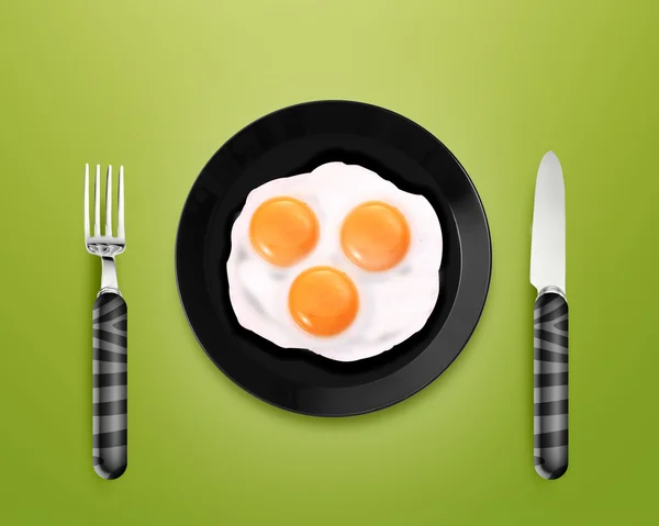 Três ovos fritos em uma chapa — Fotografia de Stock