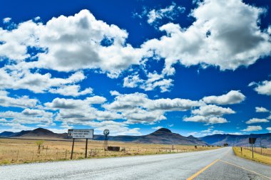 Road through a desolate landscape clipart