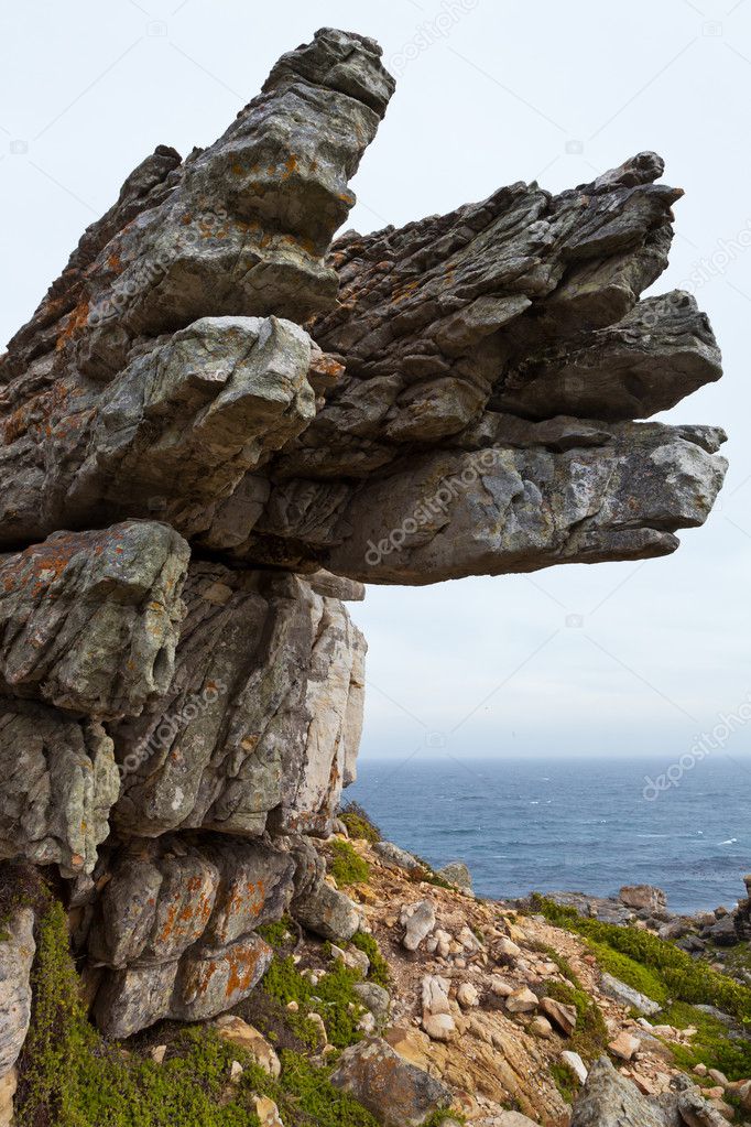 Big overhanging rock near the ocean