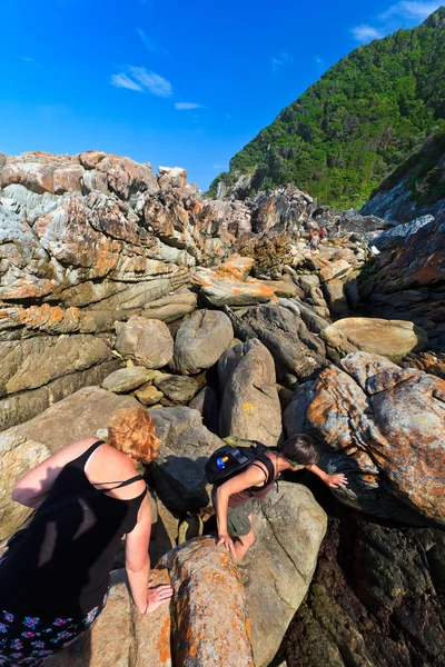 stock image Women hiking along the Rocky coastline